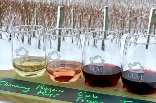 Four wines on a board labelled with their respective names. Situated in front of a snowy field.